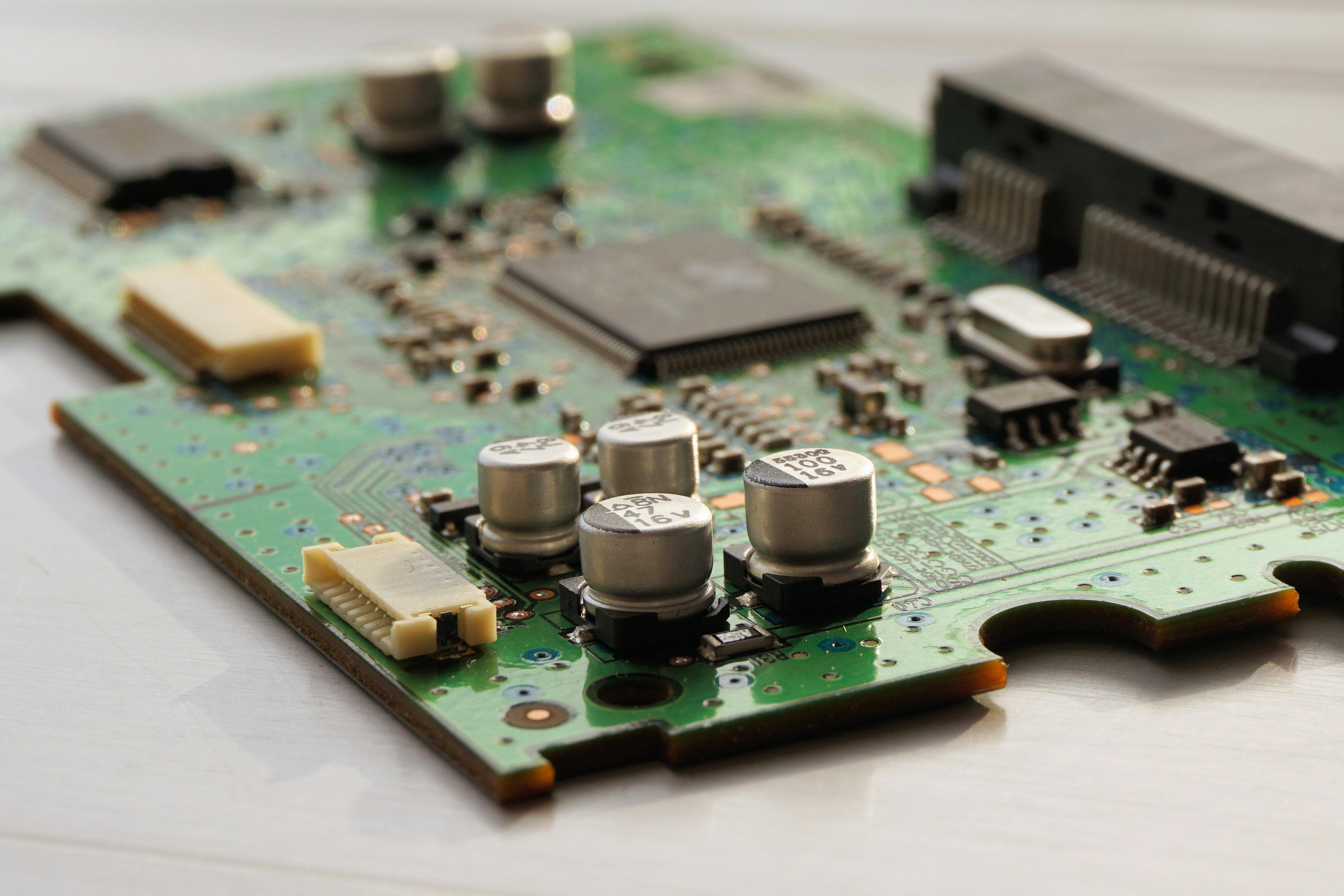 Close-up of a professionally assembled PCB showing ferrite beads, vias and SMD components